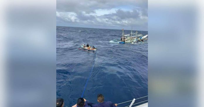 Philippine Coast Guard personnel tow distressed fishing vessel FBCA Kim Syvil during a rescue operation southwest of Nogas Island in Anini-y, Antique, where nine fishermen from Puerto Princesa City, Palawan were safely recovered amid rough sea conditions. COAST GUARD DISTRICT WESTERN VISAYAS PHOTO