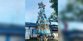 DULL TO THE EYE BUT RICH IN MEANING. Sagay Component City Police Office’s unique Christmas tree is adorned with seized noisy mufflers and fake driver’s license cards, symbolizing law enforcement and public awareness. SCCPO PHOTO