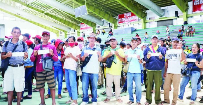 neljoy_crop_insurance Typhoon-hit rice and corn farmers in Passi City display their indemnity checks after receiving crop insurance payouts from the Philippine Crop Insurance Corporation, part of more than ₱11.6 million released to help farmers recover from weather-related losses.
