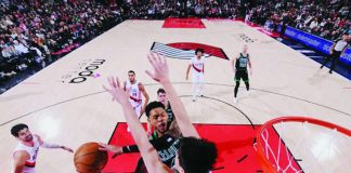 Portland Trail Blazers center Yang Hansen foils the shot attempt of Boston Celtics guard Anfernee Simons. GETTY IMAGES