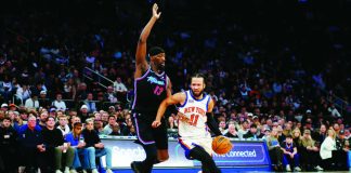 New York Knicks guard Jalen Brunson (11) dribbles around Miami Heat center Bam Adubayo (13) during the first half of an NBA basketball game Sunday, Dec. 21, 2025, in New York. AP