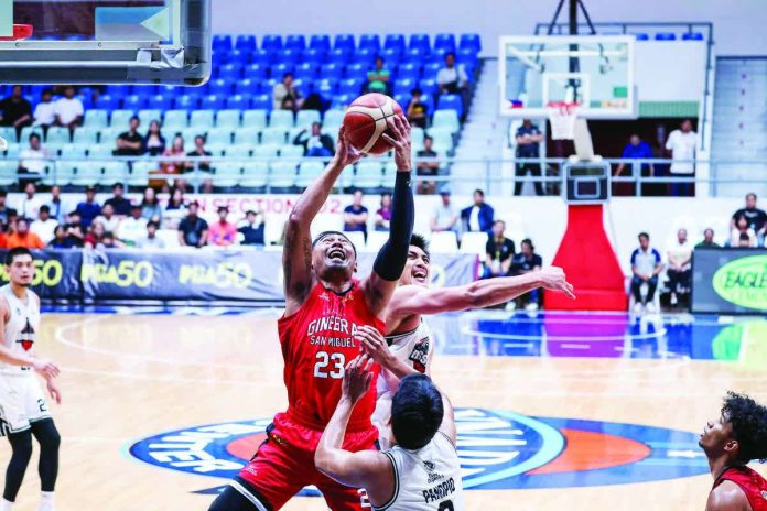 sports_Ginebra_resized_resized_compressed Barangay Ginebra San Miguel Kings’ Raymond Aguilar beats Blackwater Bossing’s Bradwyn Guinto and Dalph Panopio for the rebound. PBA PHOTO