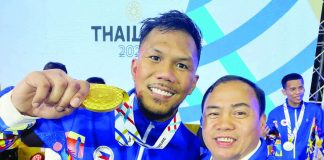 Eumir Marcial celebrates his gold medal win with Negrense boxing coach Roel Velasco. FACEBOOK PHOTO