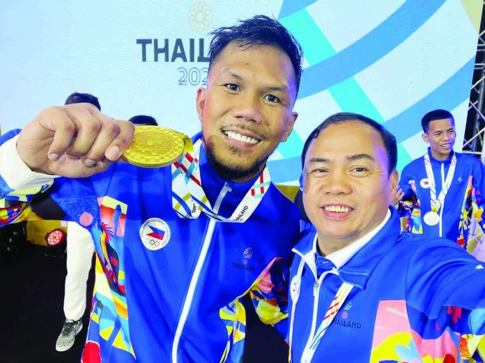 sports_Marcial_copy_resized_compressed Eumir Marcial celebrates his gold medal win with Negrense boxing coach Roel Velasco. FACEBOOK PHOTO
