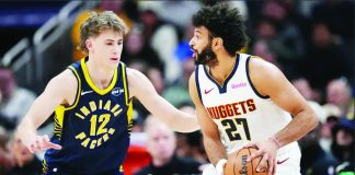 Jamal Murray of Denver Nuggets looks for an opening against Johnny Furphy of Indiana Pacers on Dec. 3, 2025, in the first quarter at Gainbridge Fieldhouse in Indianapolis. PHOTO BY DYLAN BUELL/GETTY IMAGES