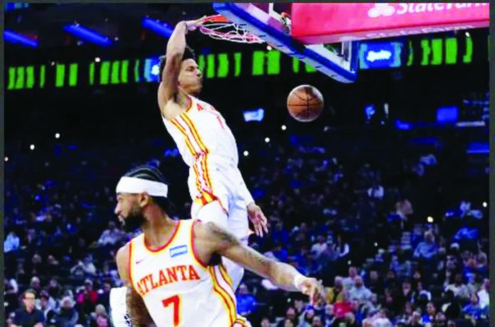 sports_NBA.JPG_resized_compressed Atlanta Hawks’ Jalen Johnson dunks the ball from the pass by Nickeil Alexander-Walker during the first half of an NBA basketball game in Philadelphia. AP