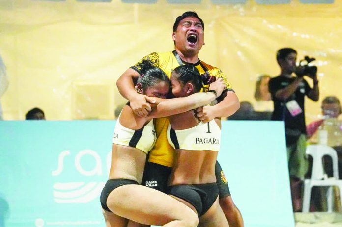 sports_UST_resized_compressed University of Santo Tomas celebrates its UAAP Season 88 women’s beach volleyball championship. UAAP PHOTO