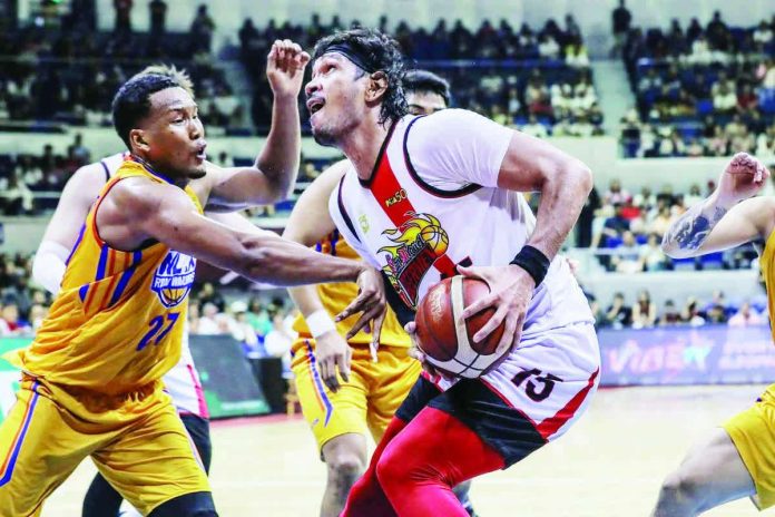 sports_san_miguel_resized_compressed San Miguel Beermen's June Mar Fajardo protects the ball from NLEX Road Warriors' Sidney Onwubere. PBA PHOTO