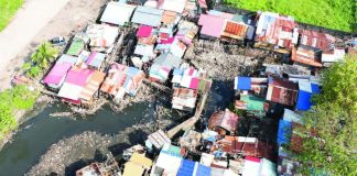 Aerial view of the 27 structures along Mambuloc Creek in Purok Balinday, Barangay 2, prior to their voluntary dismantling on January 15 following an order from the Bacolod City government, as part of ongoing construction and repair works to mitigate flooding in the area. BACOLOD-STRONGER TOGETHER FB PHOTO