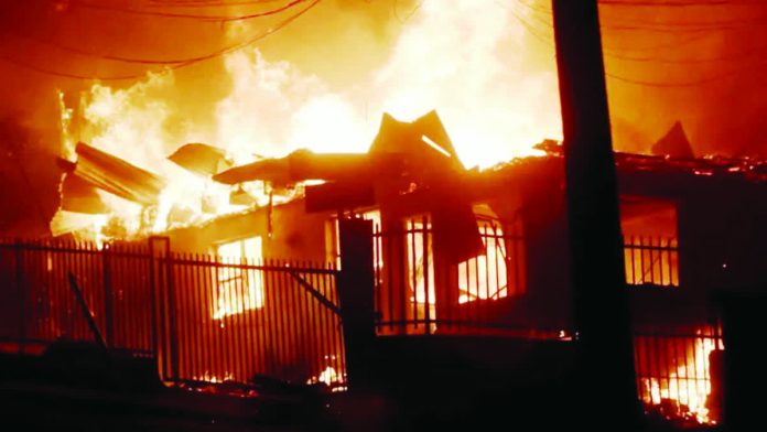 Chile_copy_resized_compressed Houses affected by forest fires burn in Penco, Chile. More than 250 homes have been destroyed so far. EPA