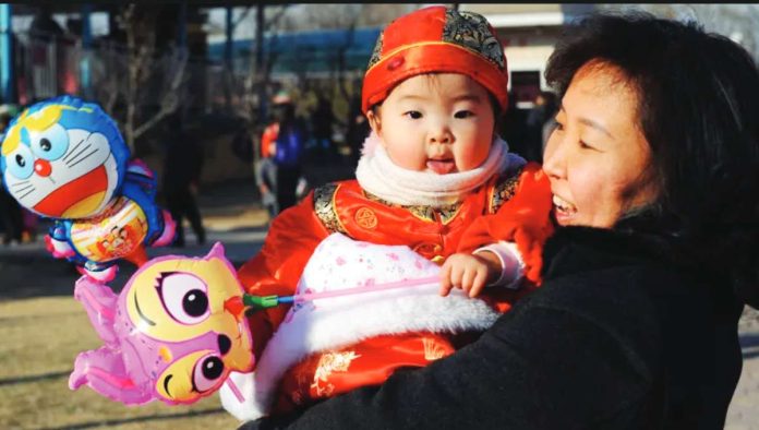 China A Chinese woman is laughing while holding a baby girl. China’s birth rate fell to 5.63 per 1,000 people – a record low since the Communist Party took power in 1949. AFP VIA GETTY IMAGES