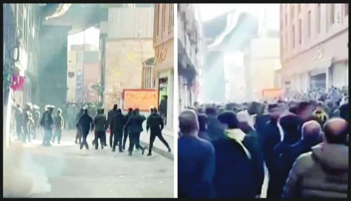 Iran This composite image of two screengrabs from video obtained by BBC Persian shows Iranian riot police firing tear gas to disperse a protest in Tehran's Grand Bazaar on January 6, 2025. BBC