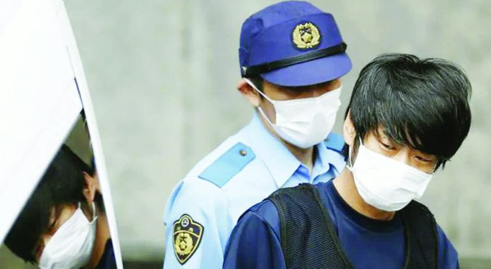 Japan_copy_resized_compressed Tetsuya Yamagami, suspected of killing former Japanese Prime Minister Shinzo Abe, is escorted by a police officer as he is taken to prosecutors, at a police station in Nara. REUTERS