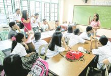 A teacher at Ramon Magsaysay (Cubao) High School in Quezon City listens to concerns raised by her students during the start of classes in this photo taken in 2018. INQUIRER PHOTO