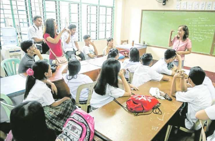 Over 10 towns suspend classes, school work to honor teachers A teacher at Ramon Magsaysay (Cubao) High School in Quezon City listens to concerns raised by her students during the start of classes in this photo taken in 2018. INQUIRER PHOTO