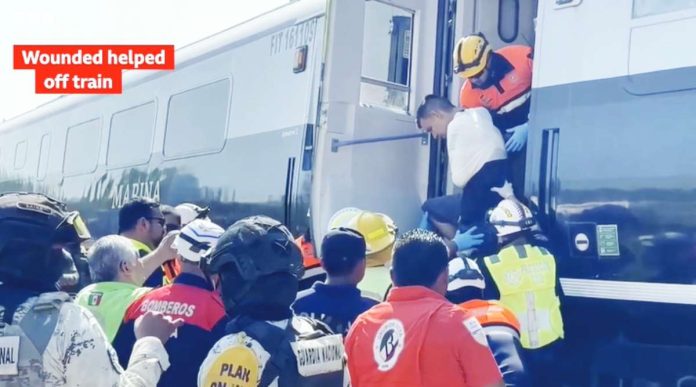 Mexico Rescuers gather at a derailed train as a wounded is being helped from a carriage. BBC