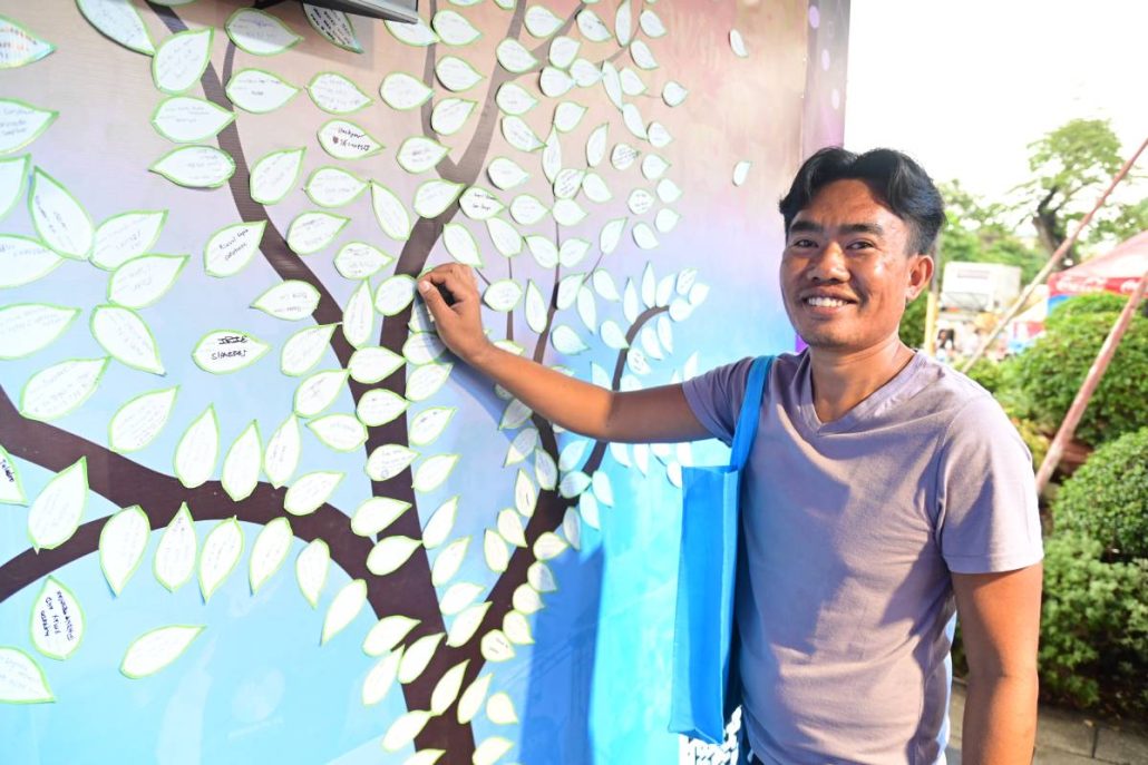Niño Algar from Cogon Pardo, Cebu City pens his heart’s desire at the BingoPlus and DigiPlus Foundation’s Wish Tree, a wish for recovery after the devastation of November 2025.