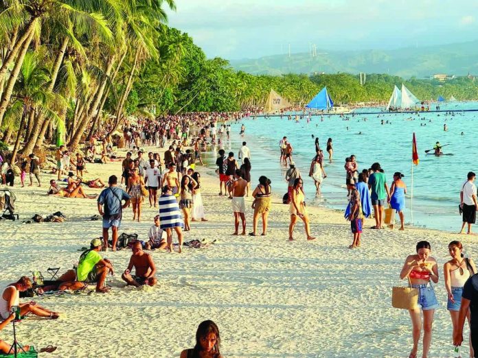 PH_tourists_resized_compressed Tourists enjoy Boracay Island in this photo taken in December 2025. The Department of Tourism on Tuesday, Jan. 20, 2026, reported that the Philippines recorded 6.5 million foreign visitors and returning overseas Filipinos in 2025. RELAKS KALANG CH/FACEBOOK PHOTO