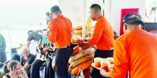 Philippine Coast Guard crew attend to survivors of the sunken M/V Trisha Kerstin 3 in the waters off Basilan province. PHOTO BY HANDOUT / PHILIPPINE COAST GUARD (PCG) / AFP