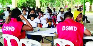 Personnel of the Department of Social Welfare and Development distributes Assistance to Individuals in Crisis Situations (AICS) in this undated photo. A provision in the proposed 2026 national budget bars elected officials from any role in the release or distribution of government assistance — whether in cash or in kind. PNA