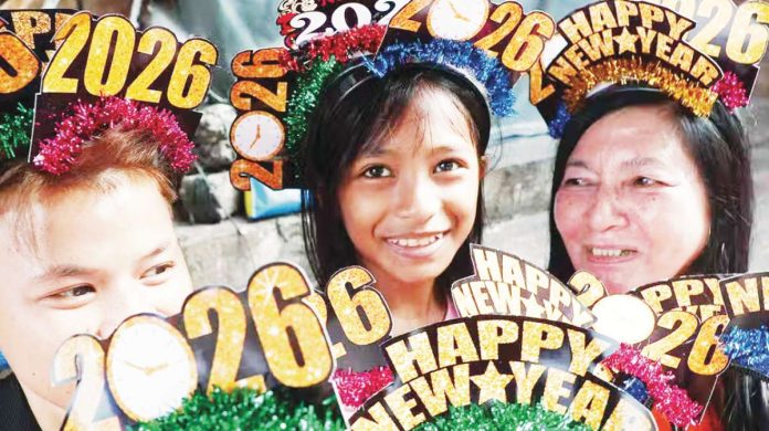 A family in Binondo, Manila greet 2026 with their novelty headgear on New Year’s Eve. A survey conducted by the Social Weather Stations shows that while most Filipinos look to the New Year with hope, many are fearful of what it could bring. INQUIRER / MARIANNE BERMUDEZ
