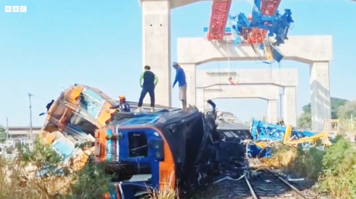 Thailand Emergency responders clamber over a mangled train after a crane collapsed in Thailand. BBC