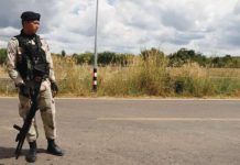 A Thai soldier stands on a road near the border with Cambodia. EPA
