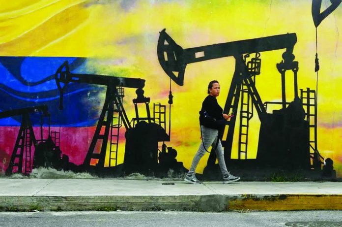 US-Venezuela_tension_copy_resized_compressed The Department of Energy says the current oil crisis following the tension between the United States and Venezuela might not actually be a major impact on the global market, especially in the Philippines. Photo shows a local walking past a mural featuring oil pumps and wells in Caracas, Venezuela, on January 6, 2026. PHOTO COURTESY OF AP