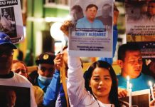 Venezuelan government begins releasing political prisoners A group of protesters with a woman centered hold candles and signs of people who have been made political prisoners in Venezuela. EPA