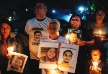 Venezuela frees dozens more political prisoner Venezuelans participate in a vigil outside the Rodeo I prison in Zamora holding up images and candles. EPA