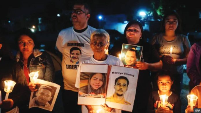 Venezuela Venezuelans participate in a vigil outside the Rodeo I prison in Zamora holding up images and candles. EPA