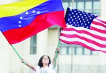 ‘A long road ahead’: Venezuelans react to Maduro arrest with hope and worry A Venezuelan living in Colombia waves a Venezuelan flag and a US flag at Plaza de Bolivar, in Bogota. REUTERS