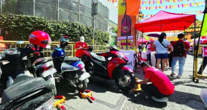 clamping The Iloilo City Traffic and Transportation Management Office (ICTTMO) reminds motorists to be disciplined and responsible during the Dinagyang Festival, adding that clamping operations will continue, and violators will be dealt with accordingly. Photo shows ICTTMO personnel putting clamps on motorcycles for illegal parking on Valeria Street, City Proper district. PN FILE PHOTO