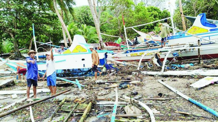 ime_concepcion_boats_copy_resized_compressed Fisherfolk inspect damaged pump boats strewn along the shoreline of Barangay Igbon, Concepcion, Iloilo after strong waves battered the coastal village over the weekend, destroying and damaging dozens of fishing vessels — the primary source of livelihood and transport for residents. PHOTO CONTRIBUTED BY AIROSE C. CALINAO