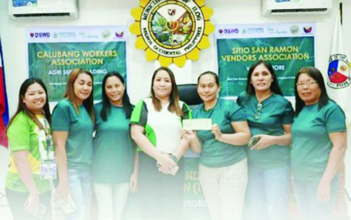 Personnel of Department of Social Welfare and Development-Negros Island Region turn over a check for seed capital fund (SCF) to a sustainable livelihood program association in Ilog, Negros Occidental in this photo released on Friday, Jan. 9, 2026. DSWD-NEGROS ISLAND REGION PHOTO