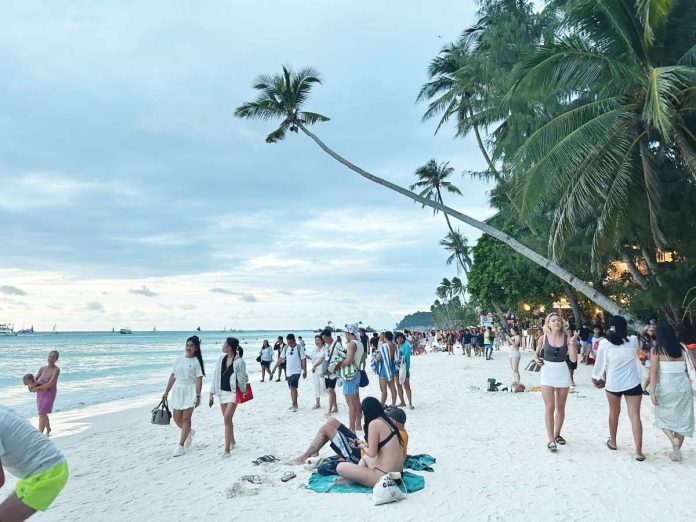 neljoy boracay warning copy Tourists stroll along White Beach in Boracay Island as authorities warn travelers to transact only with accredited tourism operators amid a rise in unregistered and online scam-prone tourism service providers. PHOTO FROM X