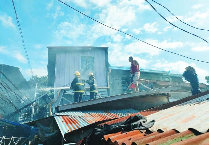 neljoy fire copy Firefighters battle a blaze that tore through tightly packed houses in Zone 1A, Barangay San Juan, Molo, Iloilo City on Sunday afternoon, January 18, leaving several homes destroyed and dozens of residents displaced. AJ PALCULLO/PN