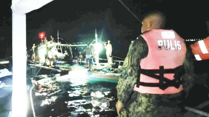 neljoy fish copy Personnel of the Iloilo Provincial Bantay Dagat Task Force, backed by police operatives, intercept a fishing vessel during a nighttime seaborne patrol in the municipal waters of Ajuy, Iloilo, leading to the arrest of a fisherman caught using the banned round haul seine or “sensuro” method. PHOTO FROM DR. RAUL BANIAS