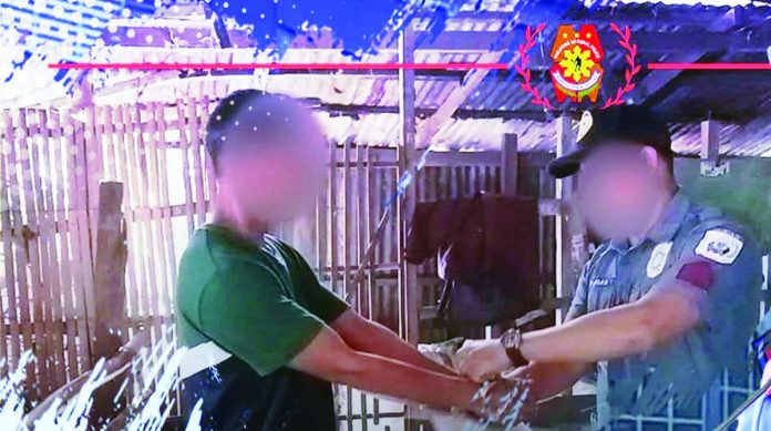 A police officers arrests Western Visayas’ Top 1 most wanted person in Barangay Sibucauan, Tubungan, Iloilo on January 7, 2026. The suspect faces three counts of qualified rape involving a minor and is now in police custody pending court proceedings. PRO-6 PHOTO
