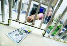 Peso flirts with new record low amid bullish dollar run An employee at a money exchange shop on A. Mabini Street in Manila accepts a hundred-dollar bill from a customer so it can be converted into pesos. Photo by LYN RILLON / Philippine Daily Inquirer