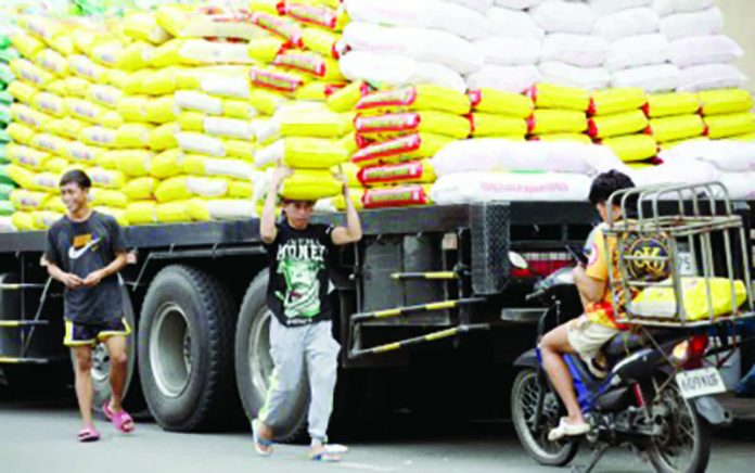 Workers unload sacks of imported rice for retailers in Tondo, Manila on Nov. 7, 2025. The Department of Agriculture on Jan. 8, 2026 assured there will be no upward trend in the retail prices of imported and local rice amid the lean months in the country. PNA PHOTO BY YANCY LIM