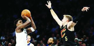 Cleveland Cavaliers’ Sam Merrill looks to foil the shot attempt of Minnesota Timberwolves' Anthony Edwards. ESPN PHOTO