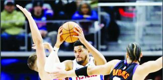 Detroit Pistons’ Tobias Harris protects the ball from the defense of Phoenix Suns’ Grayson Allen and Dillon Brooks. AP