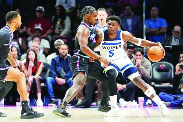 Minnesota Timberwolves' Anthony Edwards attacks the defense of Miami Heat guard Davion Mitchell. AP
