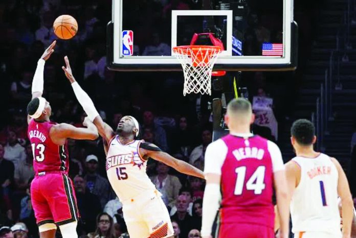 sports_Miami_resized_compressed Miami Heat’s Bam Adebayo attempts a one-handed shot against the defense of Phoenix Suns’ Mark Williams. AP Photo. AP PHOTO