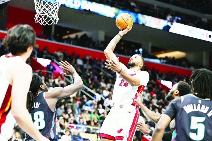 Miami Heat guard Norman Powell goes for a one-hander against the defense of Detroit Pistons; Isaiah Stewart. PHOTO COURTESY OF LON HORWEDEL/IMAGNIMAGES