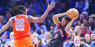 Toronto Raptors’ Immanuel Quickley looks to pass the ball after being bothered by the defense of Oklahoma City Thunder’s Cason Wallace. AP