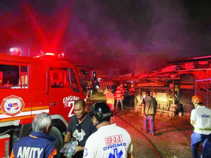 Firefighters battled a blaze that razed 11 houses in Purok Magti-ayon, Barangay 10, Bacolod City on February 11, displacing 24 families. MAYOR GREG GASATAYA FB PHOTO