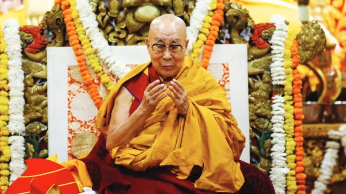 Beijing The Dalai Lama sits on a throne wreathed in floral arrangements. REUTERS