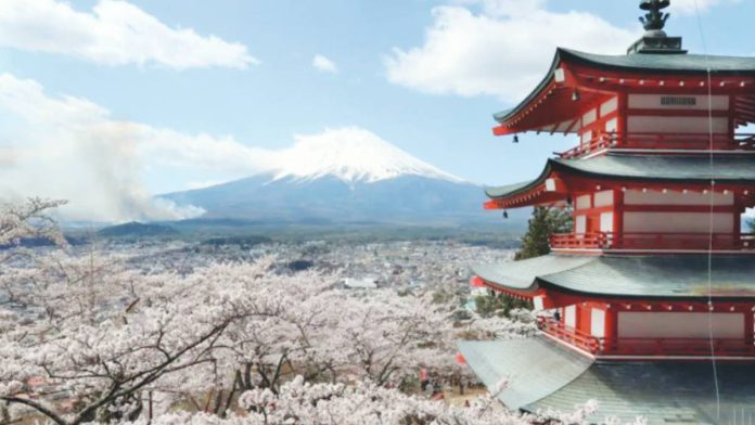Cherry blossom flowers surround a pagoda in Arakurayama Sengen park in Fujiyoshida, Japan. Mount Fuji can be seen in the background. GETTY IMAGES